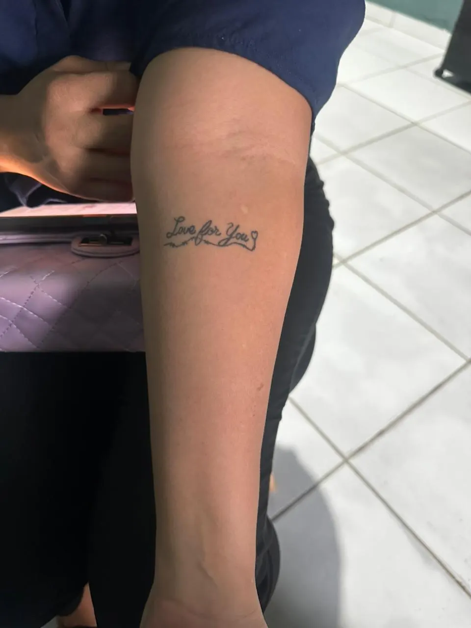 Tatuagem de frase 'Love for You' no antebraço, peça pequena que cicatriza mais rápido para quem treina